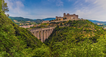 Fototapeta na wymiar The Tower Bridge spans the gorge leading to the hill top fortress in Spoleto, Italy in summer
