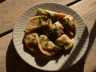 Polish food: dumplings with potato filling, served with butter and dill