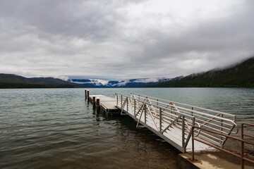 Fototapeta na wymiar Pier with mountain-range background at Lake McDonald, Glacier National Park, Montana