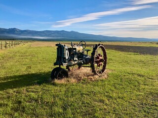 An old tractor in an open field