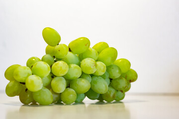 Bunch of Green Seedless Grape solated on white background.