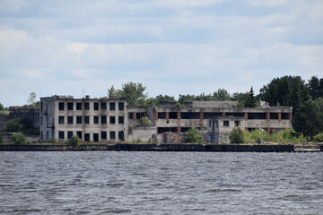Fototapeta na wymiar Abandoned buildings complex on the shore.