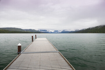 Pier with mountain-range background at Lake McDonald, Glacier National Park, Montana