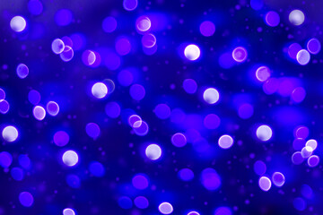 Festive Christmas sparkling defocused background. The blue lights of the holiday. Bright confetti glitter