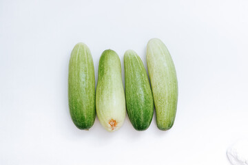 fresh green cucumbers lined up neatly. with isolated white background. copy space