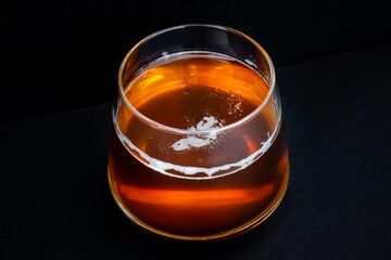 Glass of tasty beer. Light alcohol drink. Dark background. 