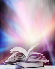 The blurred book that is bewitched with magic, the magic light in the dark, with the bright light shining down as the power to search for knowledge. For research and use as a blurred background
