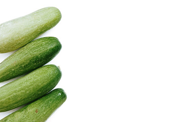 fresh green cucumbers with a background isolated white background with copyspace