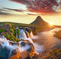 Beautiful landscape with sunrise on Kirkjufellsfoss waterfall and Kirkjufell mountain, Iceland,...