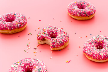 Pink berry donuts close up. Glazed and sprinkles bakery