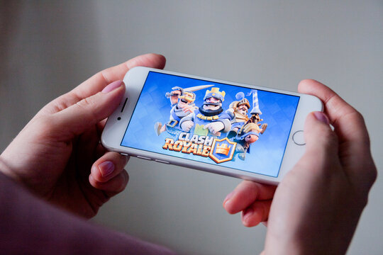 Los Angeles, California, USA - 8 March 2019: Hands holding a smartphone with Clash Royale game on display screen, Illustrative Editorial