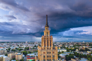Obraz premium Aerial view of iconic Riga city in dramatic sunset. Modern architecture in Europe with storm clouds