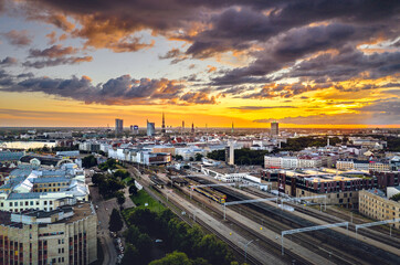 Fototapeta premium Aerial view of iconic Riga city in dramatic sunset. Modern architecture in Europe with storm clouds