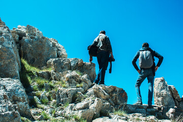 travelers climb to the top of the mountain