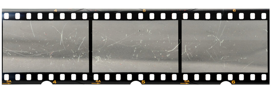 original 35mm filmstrip with empty dusty frames or cells and nice texture on the border, fluffs on film material, real film grain.