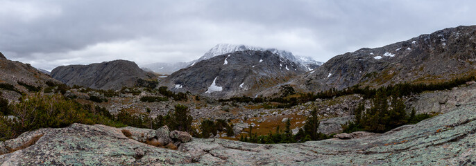 A panoramic shot of snow-capped peaks of after a snowstorm near the North Fork of Bull Lake Creek in Wyoming's Wind River Range.  Lakes 10730 and 10790 are seen in the distance.