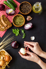 Obraz na płótnie Canvas Hands on dinner table with fresh homemade food - eggs, bread, potatoes