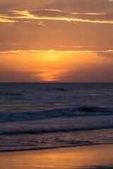Fototapeta premium Sunset with rough sea on the beach
