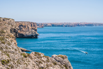 Hiking on cliffs of the Portuguese coast with idyllic turquoise sea and Sagres landscape as a background PORTUGAL