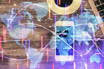 Double exposure of business theme hologram over desktop with phone. Top view. Mobile international trade connection concept.