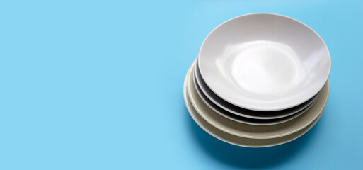 Stack of dishes on blue background.