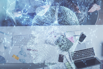 Double exposure of man and woman working together and human brain hologram drawing. Brainstorm concept. Computer background. Top View.