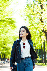 pretty young asian woman smiling cheerful in green park on summer sunny day, lifestyle people concept