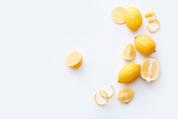 Flat lay composition with ripe juicy lemons on white background, copy space