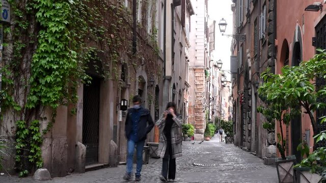 Rome Apt 7th 2020: Boy and girl with masks walk in the streets of Rome