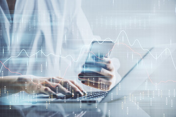 Double exposure of financial graph sketch hologram and woman holding and using a mobile device. Stock exchange concept.