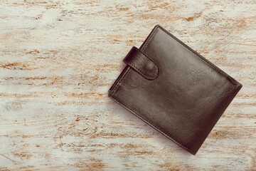 Leather man purse or wallet on wooden desk