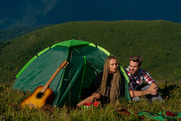 Couple in love on camp outdoors. Love, people, happiness and lifestyle concept.