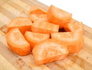 a cut sweet potato on wooden board