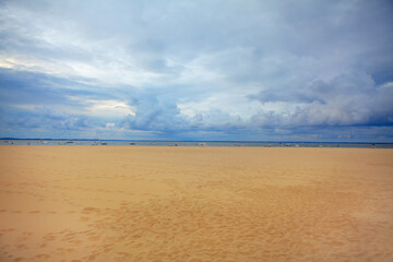 Perfect sandy beach . Beautiful low clouds over the ocean