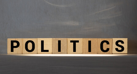 POLITICAL message word on a wooden desk on cube blocks