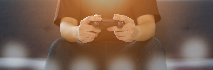 background of hands holding video and console game joystick or joypad