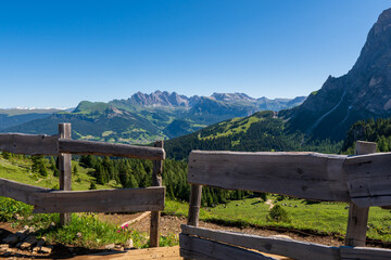meadow woth wooden fence in the dolomite alps, south tyrol, italy
