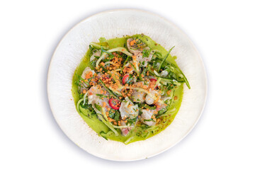 Ceviche Fricasee with green sauce and vegetables. Greek and Peruvian cuisine fusion. Top view of a healthy gourmet dish.