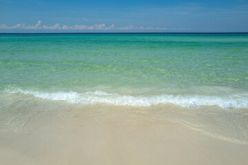 Sea beach with blue sky sand sun. Tropical paradise beach with white sand. Soft blue ocean wave on sandy beach.
