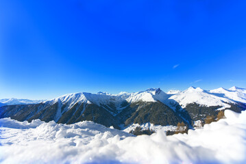 Fototapeta na wymiar Vista of snow mountain peak in Switzerland and blue sunny sky, copy space