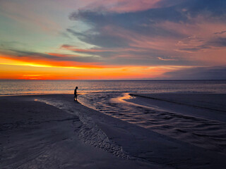 Panoramic view of sunset kid playing on the beach at Karon beach in Phuket, Thailand