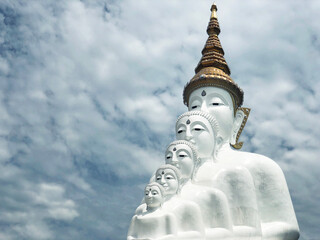 White Buddha Statue and cloud background at Wat Prathat Phasornkaew Thailand