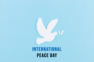 White dove made from paper cut for Peace day background with text International peace day.