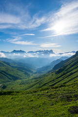 Summer morning in Dolomite Alps. Beautiful sunny landscape in the mountains. Ski hills of Piz Boe mountain in morning mist. View from Sella pass, Province of Trento, Italy, Europe.