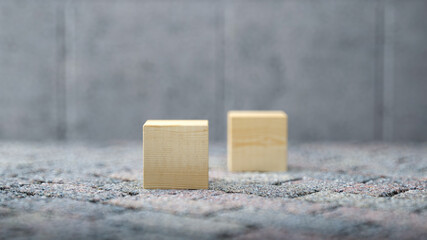 empty cubes for own message on stone pavement and conrete background