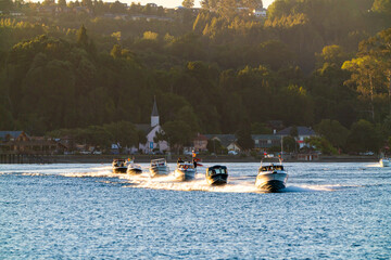 Impressive view of Lake Llanquihue with motor boats that come sailing at sunset. Frutilllar, Lake...
