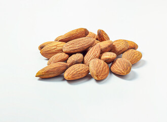 A picture natural dry almond seeds group on a white background, above view. with copy space for text