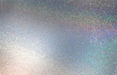 Shimmer metal texture. Abstract spectrum flare pattern. Hologram spakles. Glitz silver background.
