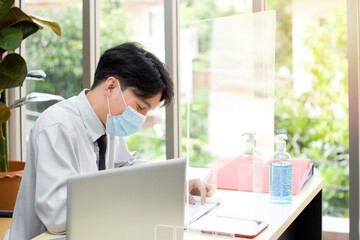 Asian male employees worked in offices during the outbreak of the coronavirus (COVID-19).