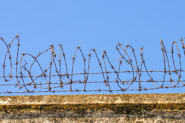 Barbed wire on a stone wall
